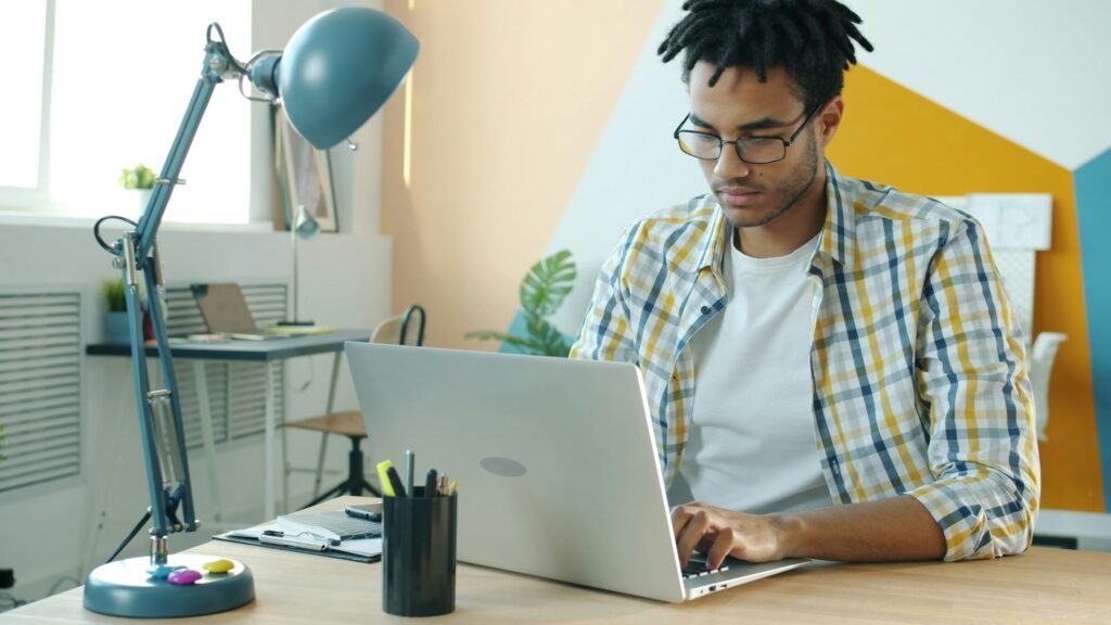 Small business owner working on a laptop to implement AI tools